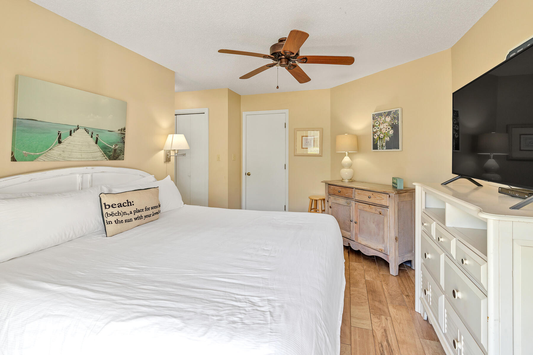 3799 East County Highway 30A, Unit D10 Santa Rosa Beach, FL 32459 - Photo 31 of 42 a bedroom with a bed and a flat tv screen on dresser