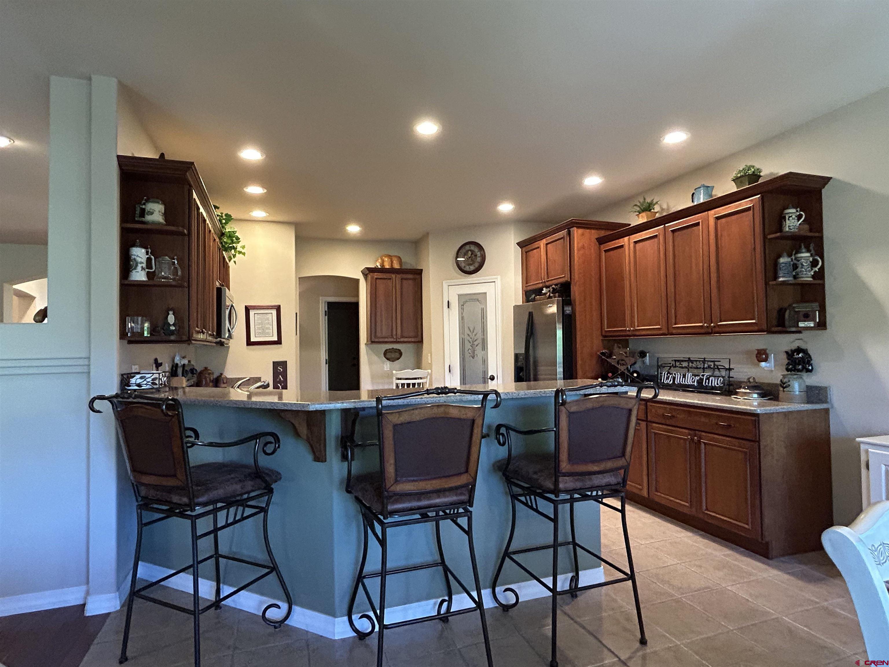850 Southeast Pinyon Street Cedaredge, CO 81413 - Photo 15 of 45 a kitchen with stainless steel appliances kitchen island granite countertop a sink and cabinets