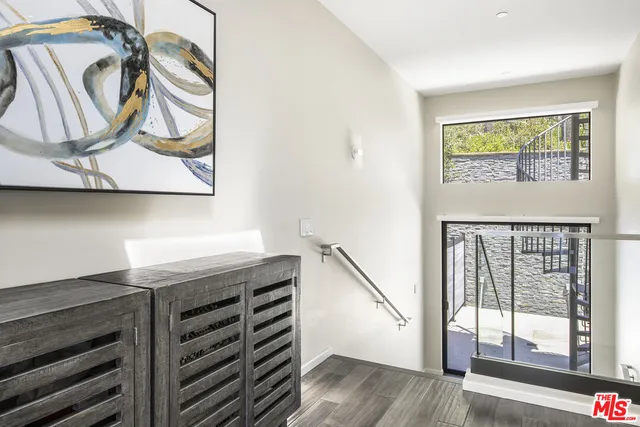 a view of an entryway with wooden floor