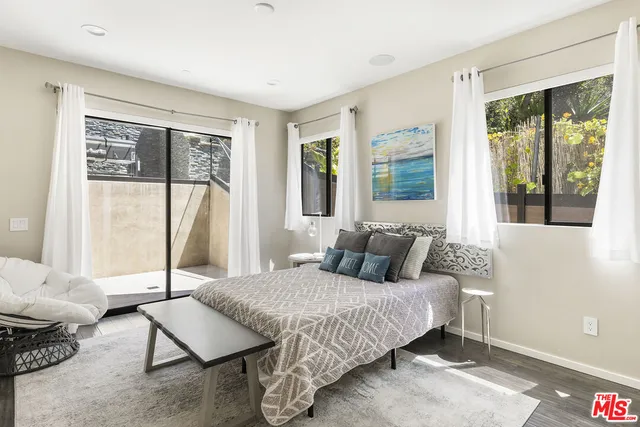 a bedroom with a bed and glass window