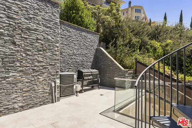 a view of a house with a small yard and wooden fence