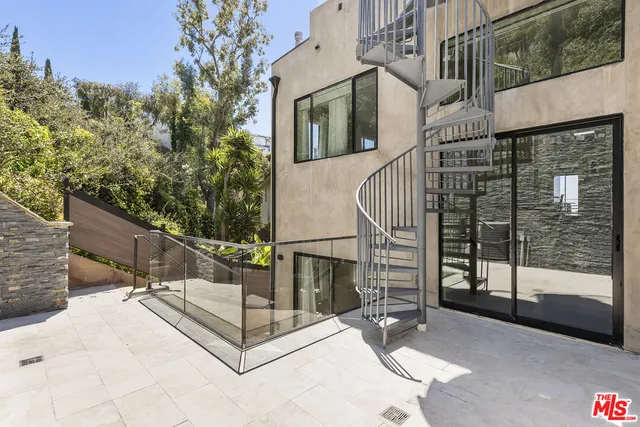a view of a roof deck with couches and sky view