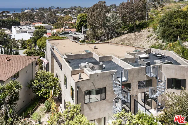 an aerial view of a house with a yard garage and a patio