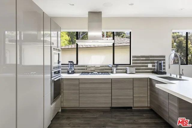 a kitchen with stainless steel appliances a sink and cabinets