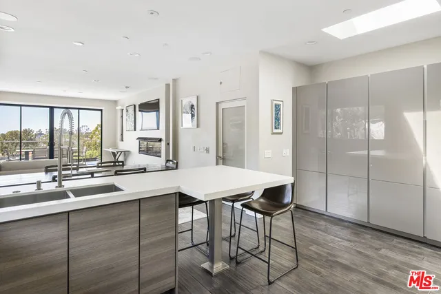 a kitchen with a table chairs refrigerator and cabinets