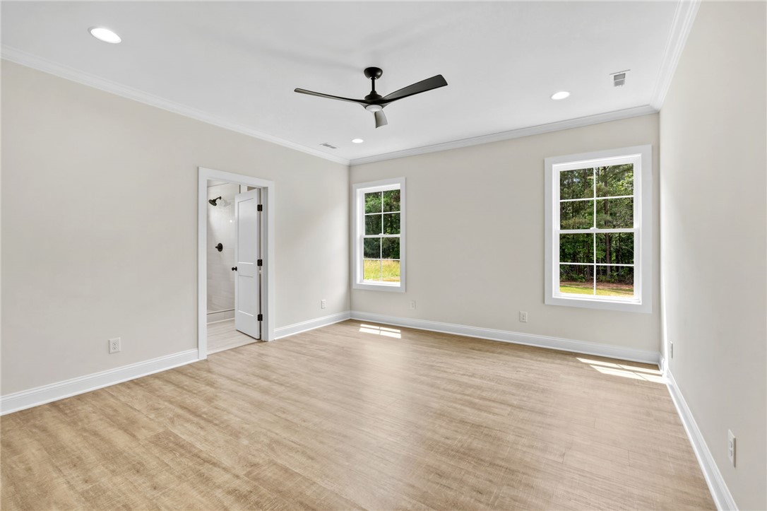1735 Maw Bridge Road Central, SC 29630 - Photo 19 of 38 This airy bedroom features modern fixtures, sleek flooring, and bright windows overlooking natural views.