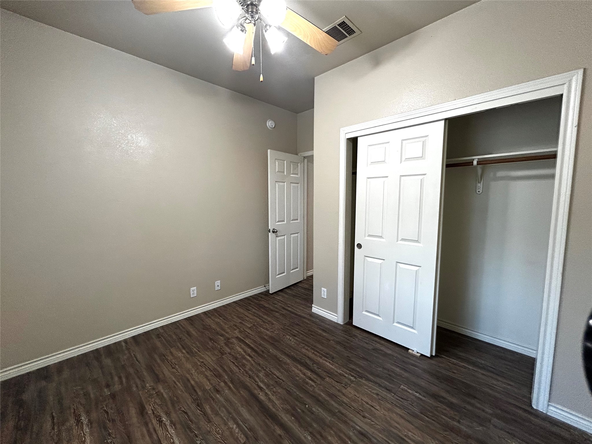 408 Nelray Boulevard, Unit A Austin, TX 78751 - Photo 23 of 36 an empty room with wooden floor closet and windows