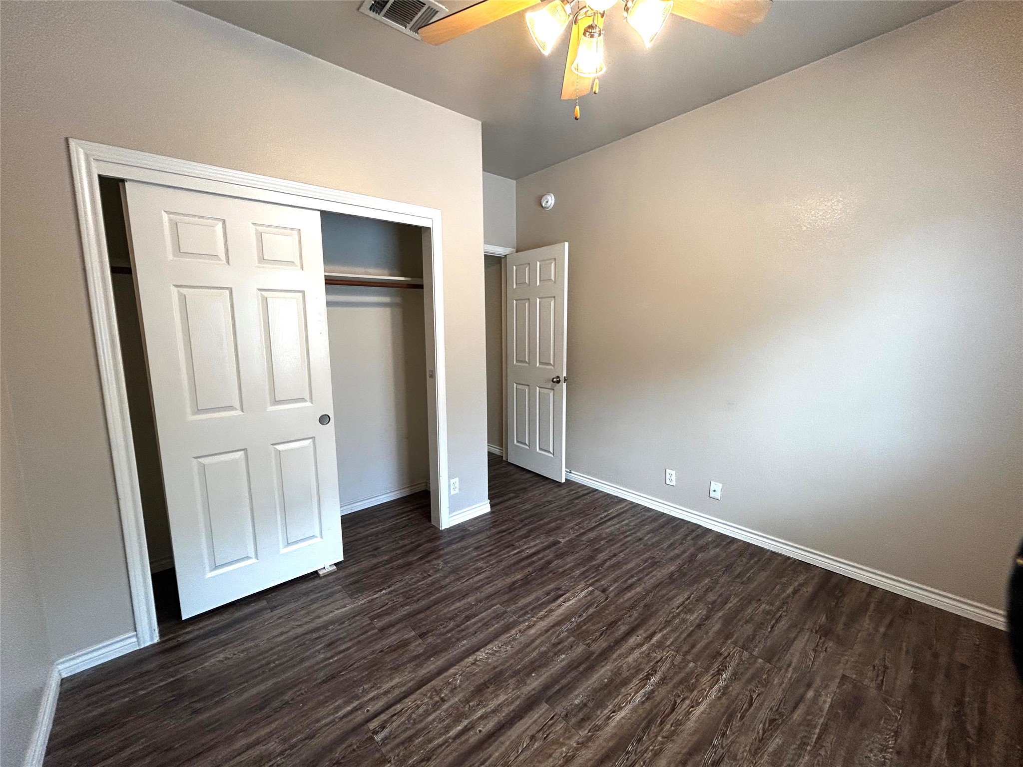 408 Nelray Boulevard, Unit A Austin, TX 78751 - Photo 27 of 36 an empty room with wooden floor and way to kitchen