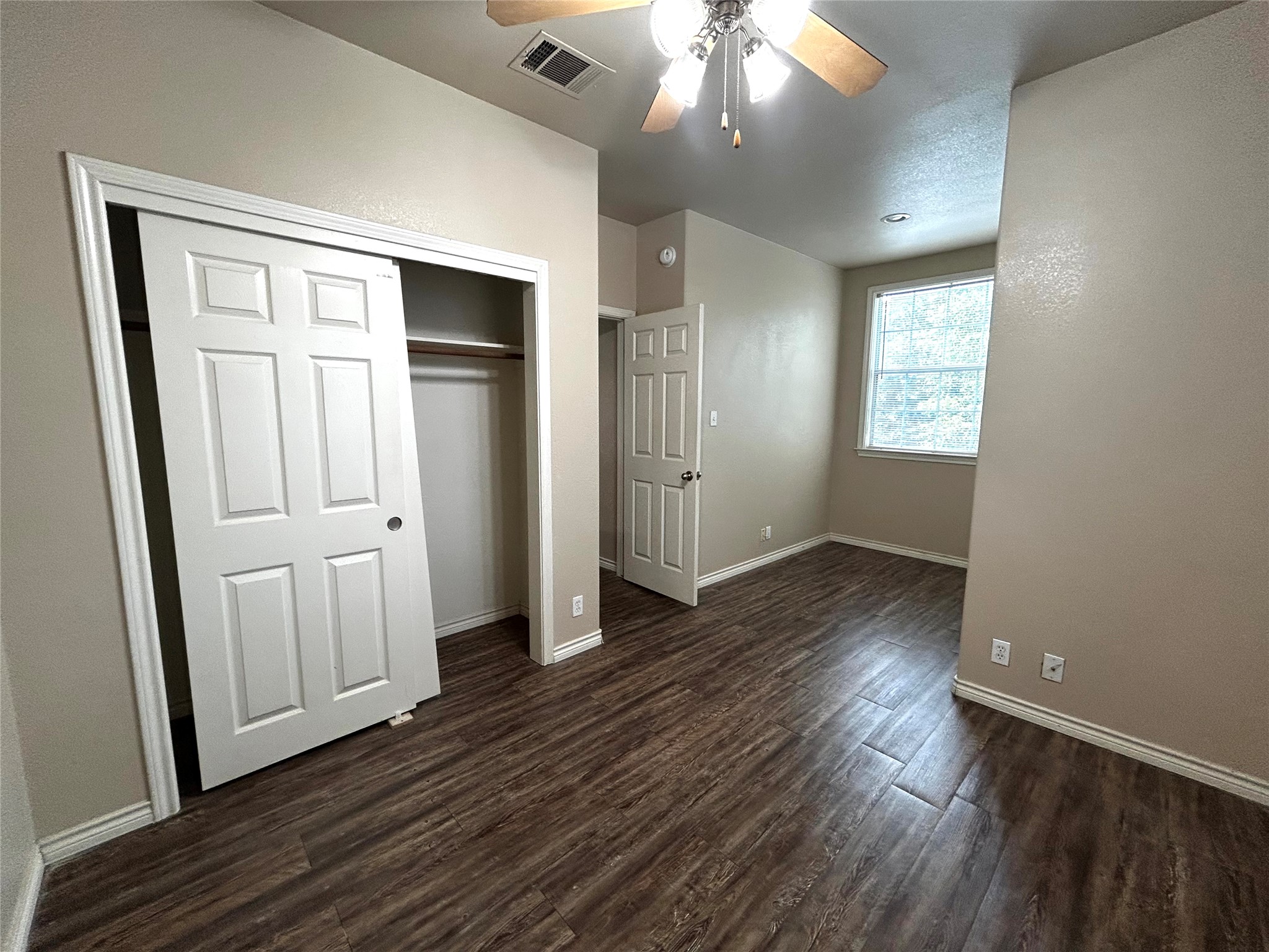 408 Nelray Boulevard, Unit A Austin, TX 78751 - Photo 29 of 36 an empty room with wooden floor and windows