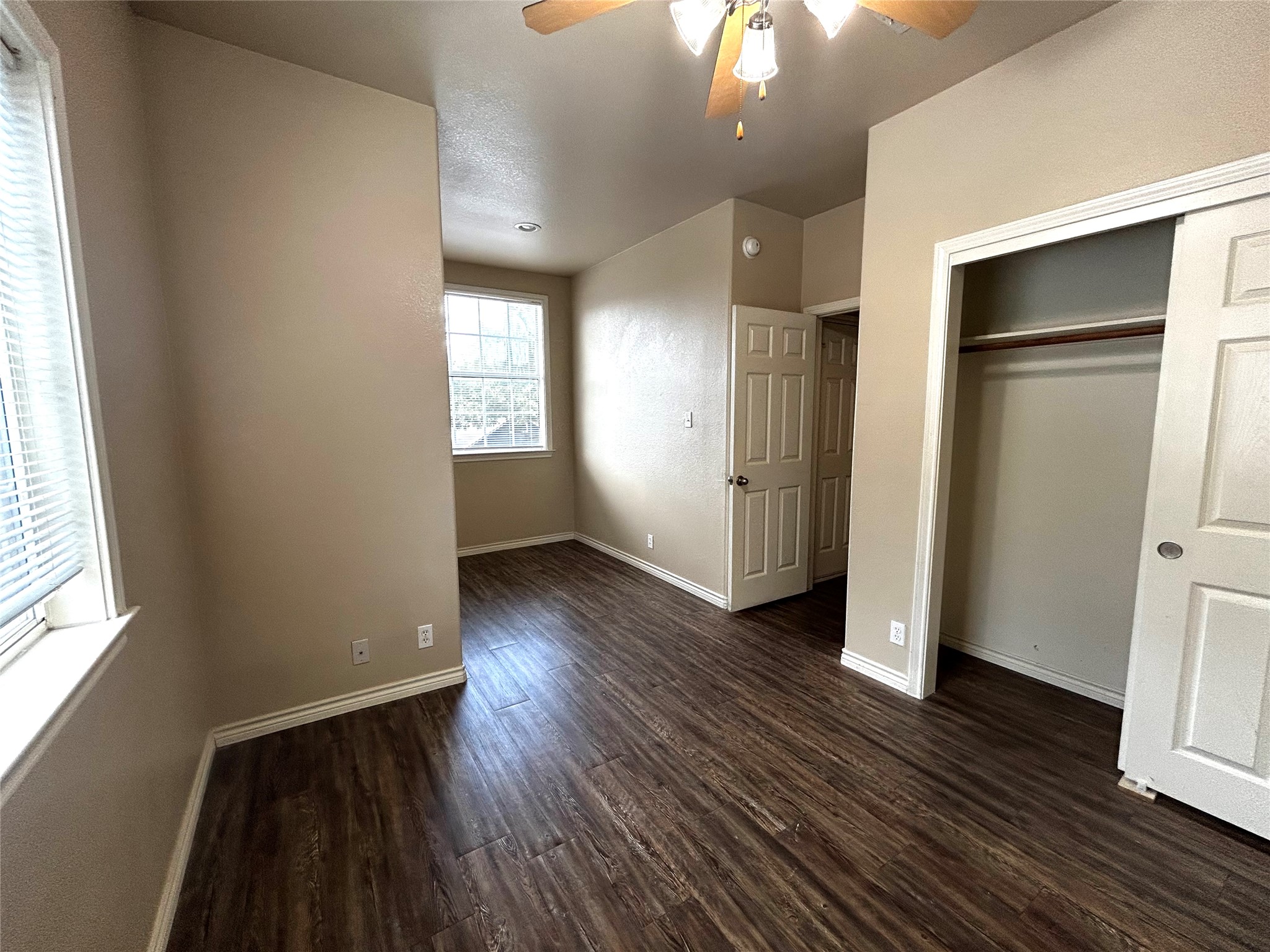 408 Nelray Boulevard, Unit A Austin, TX 78751 - Photo 34 of 36 an empty room with wooden floor cabinet and windows