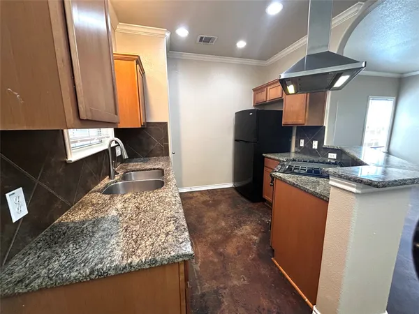 a kitchen with granite countertop a sink and a window