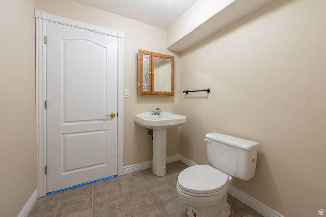 875 East 1300th Street North Mapleton, UT 84664 - Photo 26 of 65 Half bath featuring light tile patterned flooring and a textured ceiling