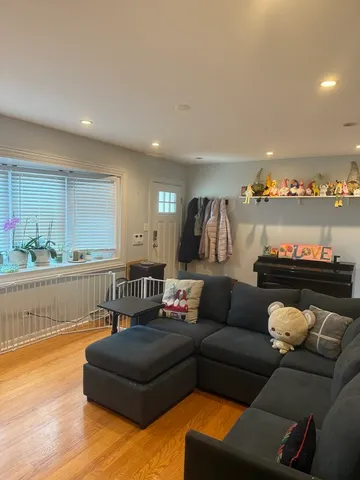 a living room with furniture and a kitchen view