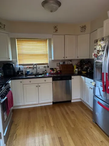a kitchen with a refrigerator and a stove top oven
