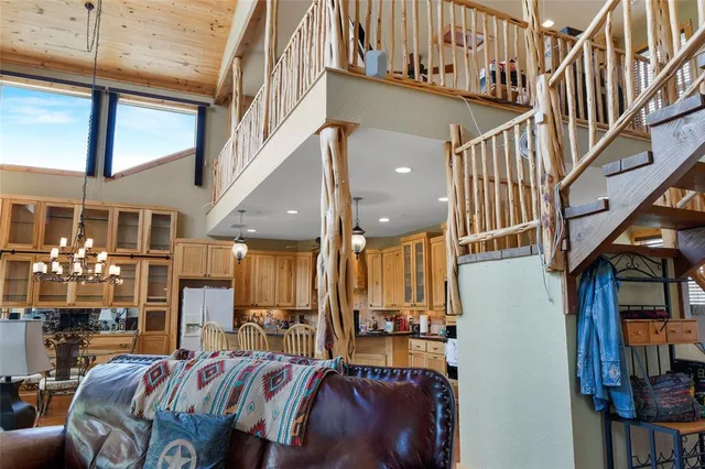 a view of staircase with lots of frames on wall and a large window