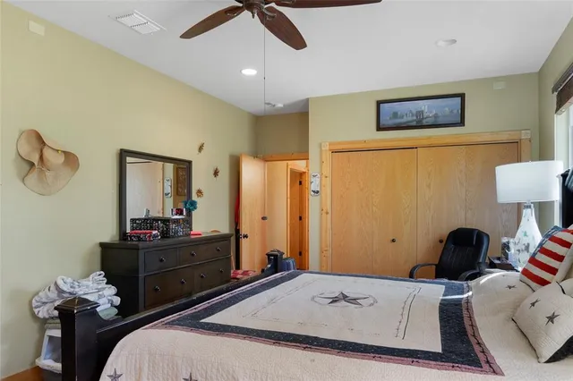 a bedroom with a bed and a large window