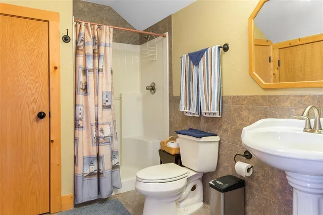 a living room with furniture a chandelier and a large window