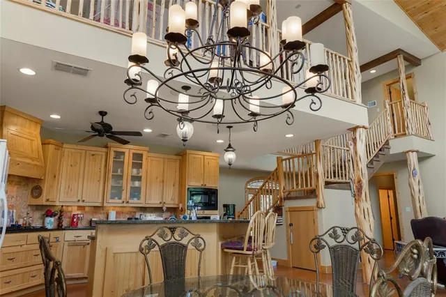 a view of a kitchen with appliances and furniture