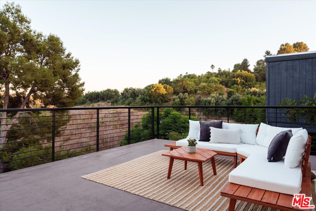 1072 Montecito Drive Los Angeles, CA 90031 - Photo 23 of 30 a roof deck with a couch and wooden floor