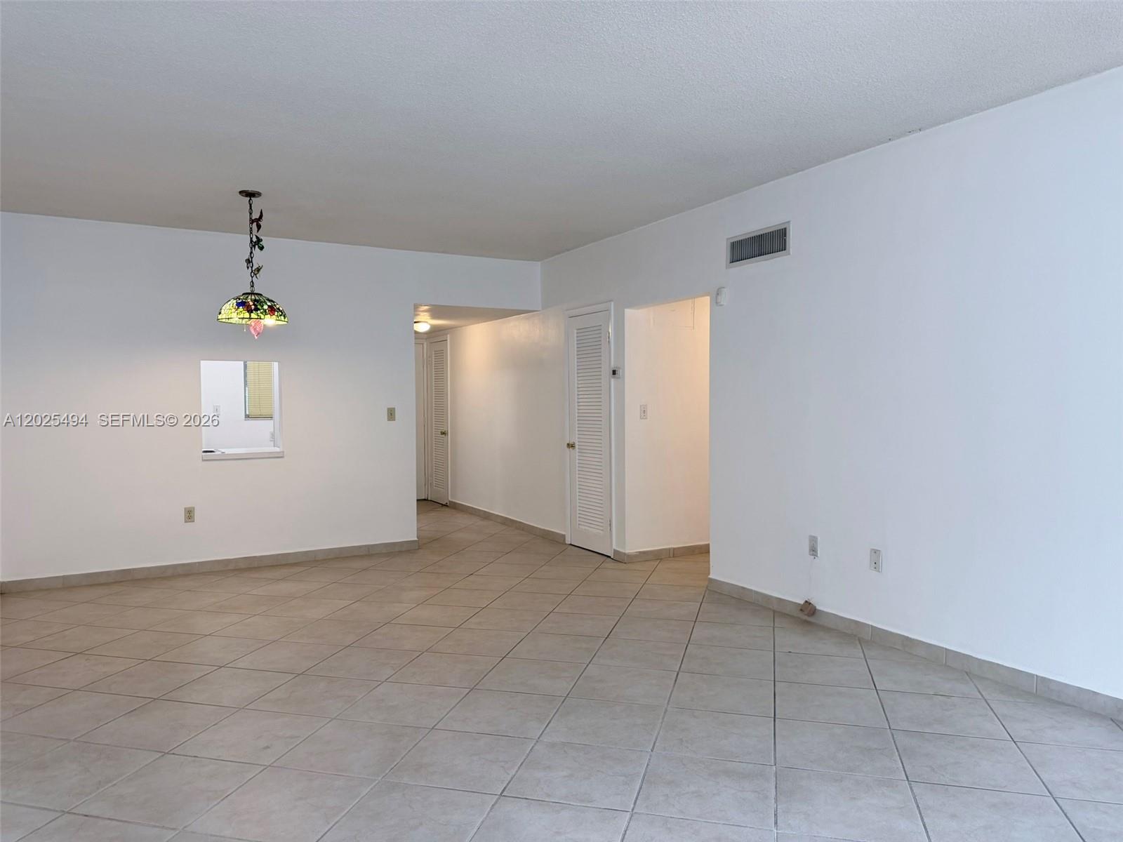 9159 Southwest 77th Avenue, Unit 112 Miami, FL 33156 - Photo 14 of 38 an empty room with closet and mirror