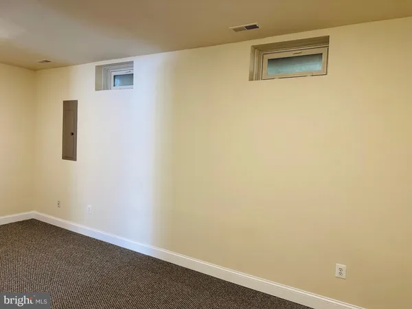 an empty room with a empty space and windows