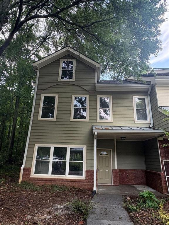 101 Dancing Fox Road Decatur, GA 30032 - Photo 1 of 1 a front view of a house with a garden