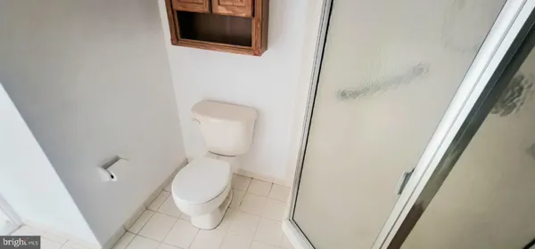 a white toilet sitting next to a small sink