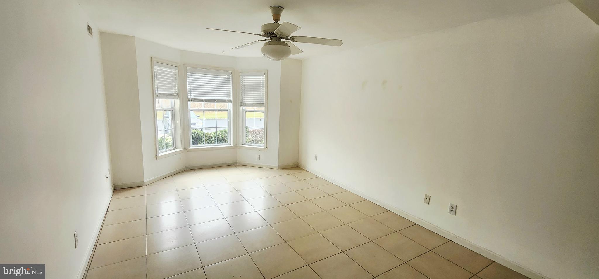 1864 Gibson Road Bensalem, PA 19020 - Photo 8 of 20 an empty room with windows and fan
