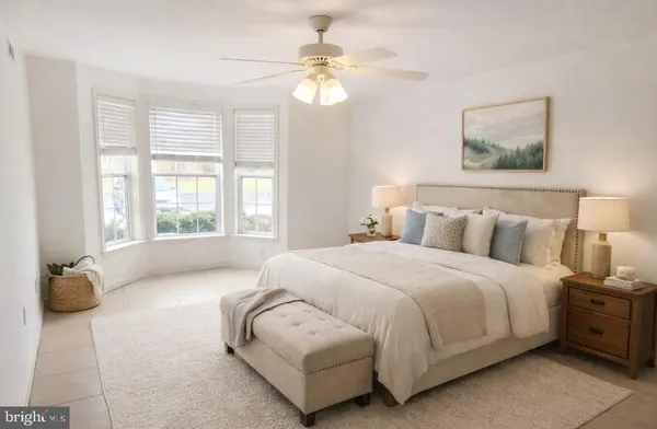 a spacious bedroom with a bed and a chandelier