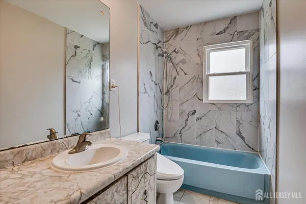 a bathroom with a sink a toilet and a bathtub