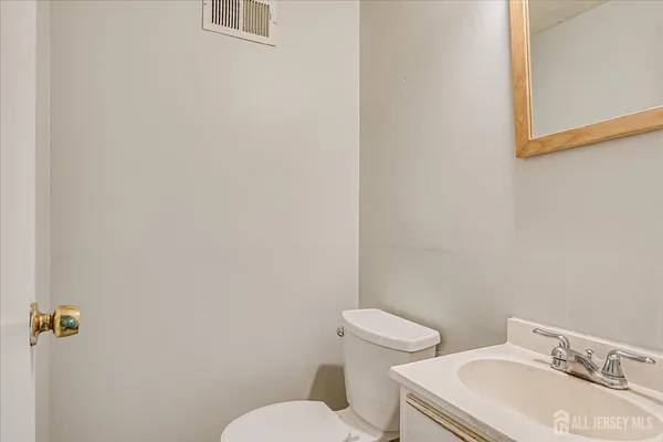 a white toilet sitting next to a bathroom sink