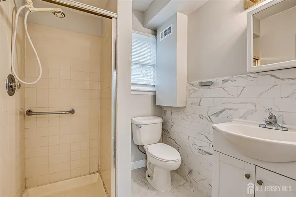 a bathroom with a toilet sink and shower