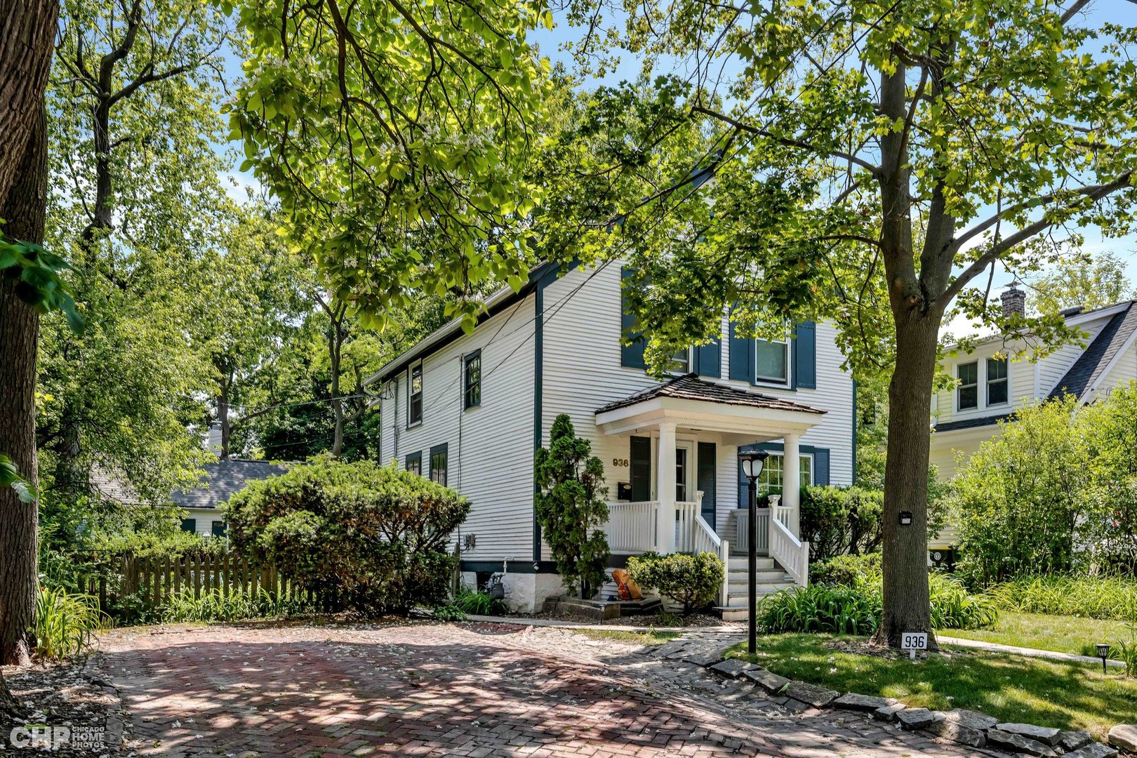 936 Spruce Street Winnetka, IL 60093 - Photo 1 of 38 a front view of a house with garden