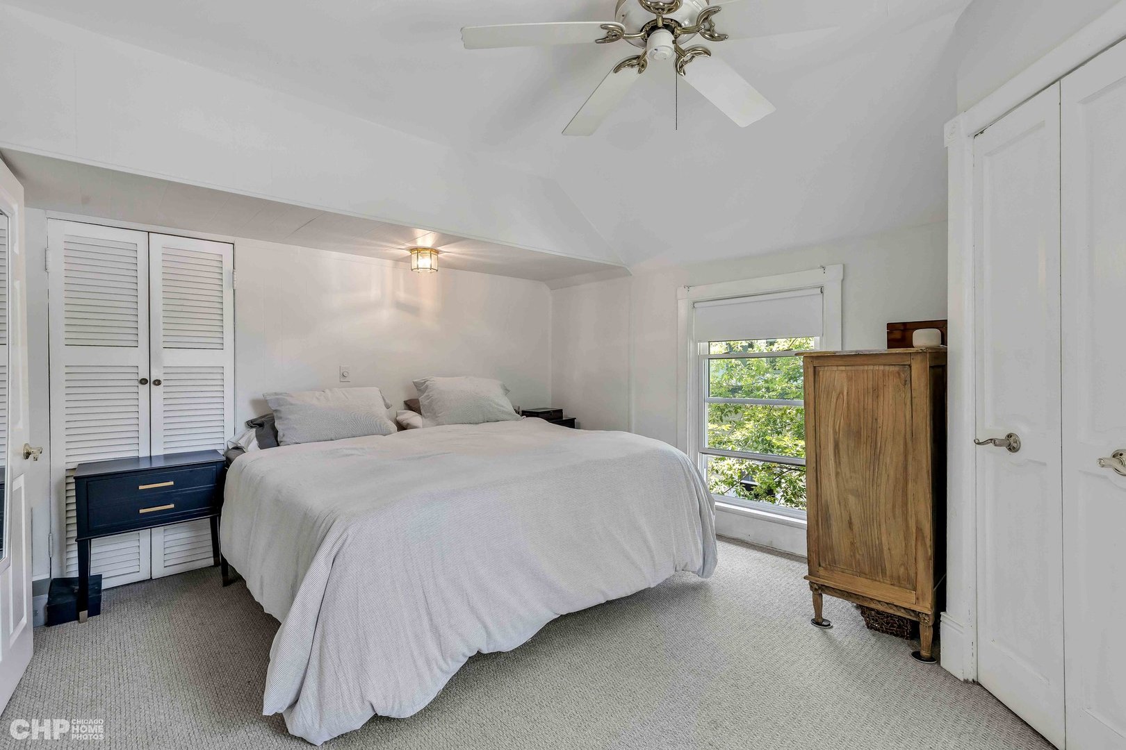 936 Spruce Street Winnetka, IL 60093 - Photo 13 of 38 a bedroom with a bed and a chandelier