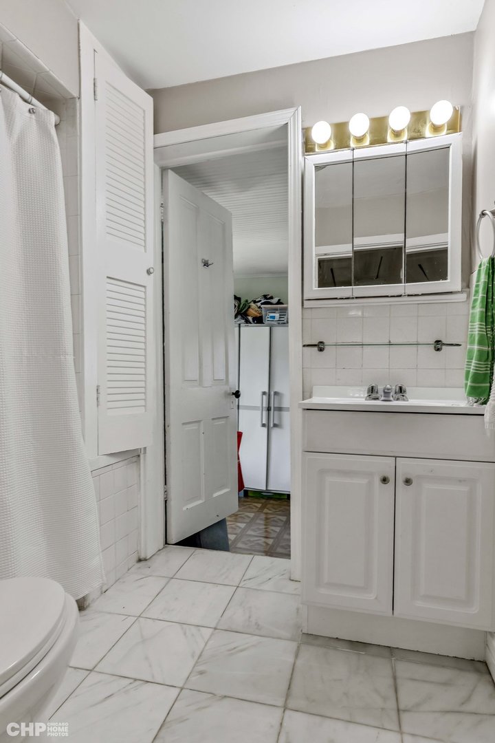 936 Spruce Street Winnetka, IL 60093 - Photo 17 of 38 a bathroom with a sink and mirror