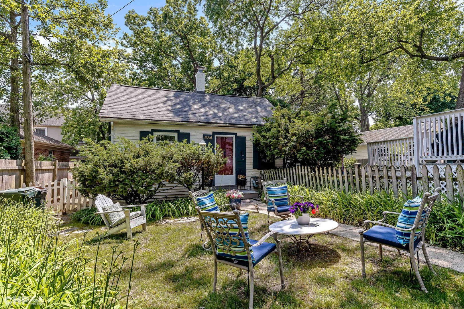 936 Spruce Street Winnetka, IL 60093 - Photo 29 of 38 a view of a chairs and table in the back yard of the house