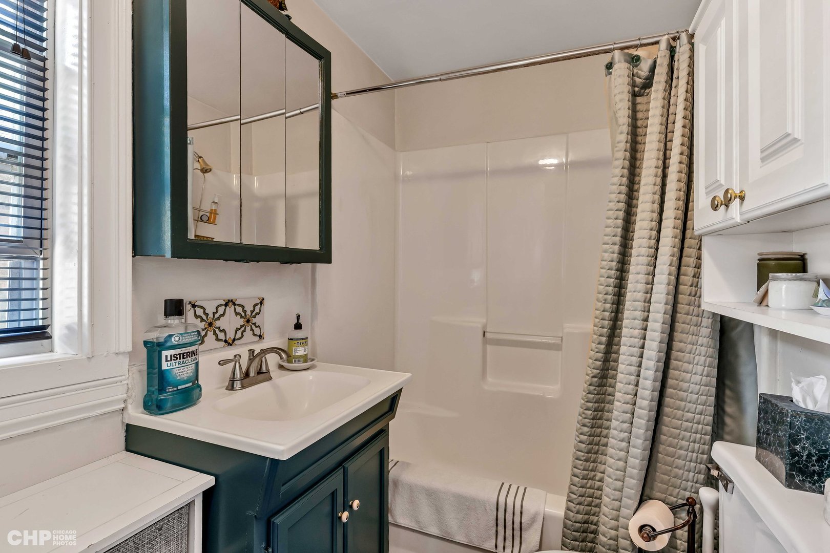 936 Spruce Street Winnetka, IL 60093 - Photo 34 of 38 a bathroom with a sink a mirror and a shower