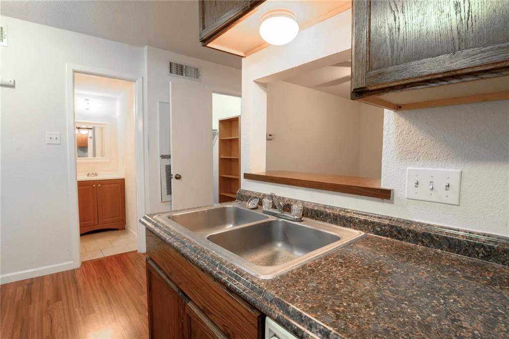 710 East Dean Keeton Street, Unit 207 Austin, TX 78705 - Photo 5 of 6 Functional kitchen with ample counter space and convenient pass-through window to adjacent living area.