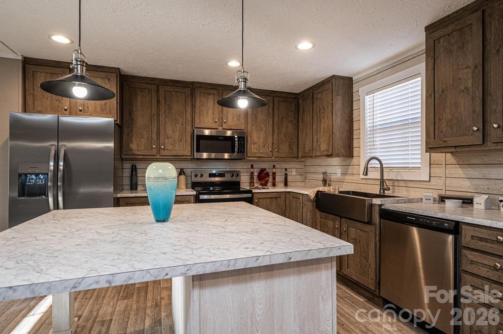 1070 Cottrell Hill Road Lenoir, NC 28645 - Photo 11 of 41 a kitchen with granite countertop a sink stainless steel appliances and cabinets