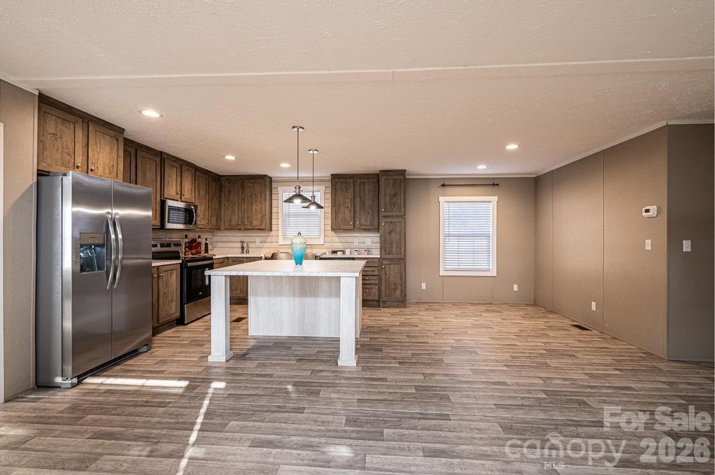 1070 Cottrell Hill Road Lenoir, NC 28645 - Photo 14 of 41 a large kitchen with kitchen island a sink stainless steel appliances and cabinets
