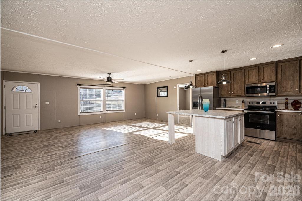 1070 Cottrell Hill Road Lenoir, NC 28645 - Photo 15 of 41 a kitchen with granite countertop a stove top oven and cabinets