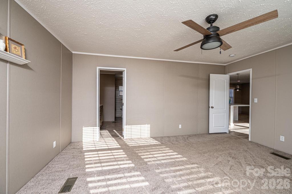 1070 Cottrell Hill Road Lenoir, NC 28645 - Photo 17 of 41 a view of a livingroom with wooden floor and a ceiling fan