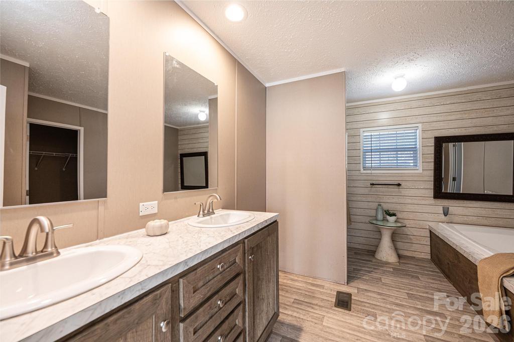 1070 Cottrell Hill Road Lenoir, NC 28645 - Photo 18 of 41 a bathroom with a double vanity sink and a mirror