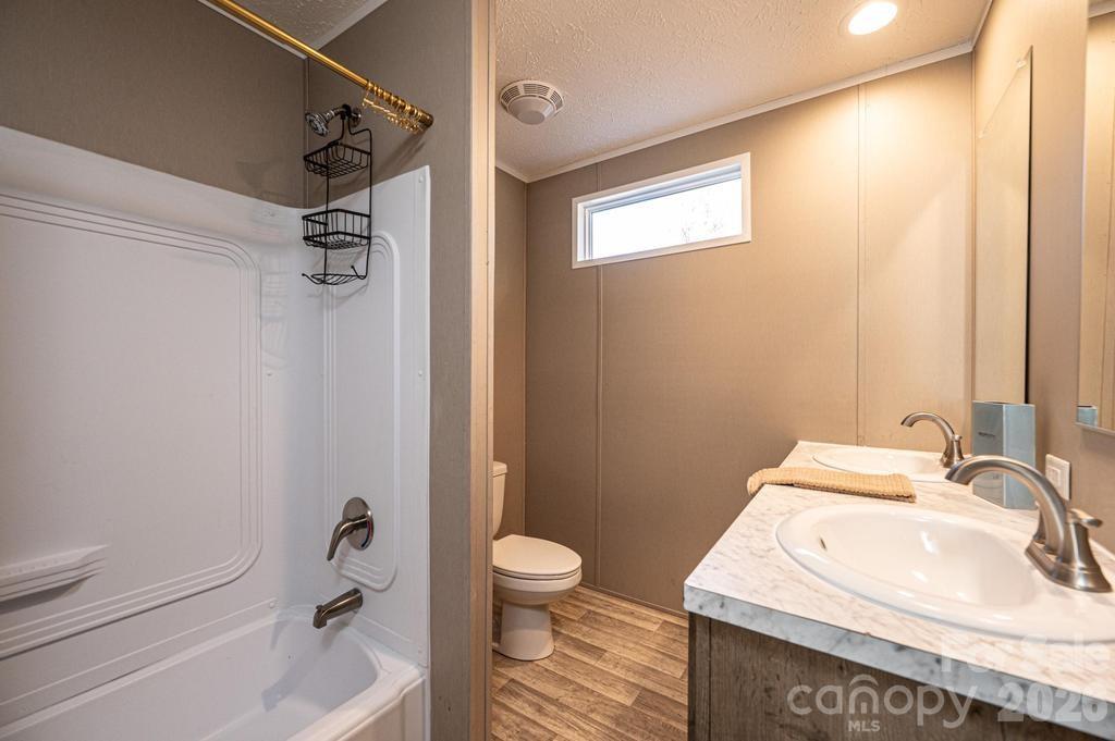 1070 Cottrell Hill Road Lenoir, NC 28645 - Photo 26 of 41 a bathroom with a sink toilet and shower