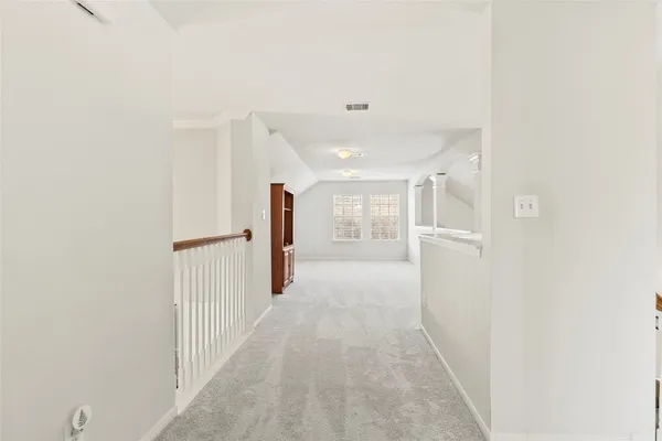 a view of a hallway with white walls