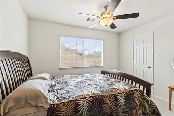 a bedroom with a bed and a window