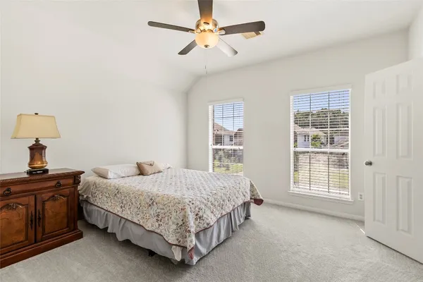 a bedroom with a bed dresser and a window