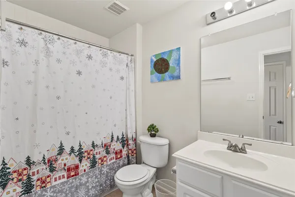 a bathroom with a sink mirror vanity and toilet