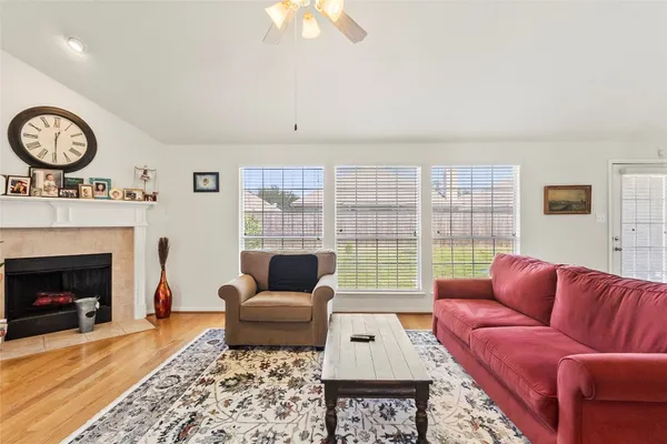 a living room with furniture a rug and a fireplace