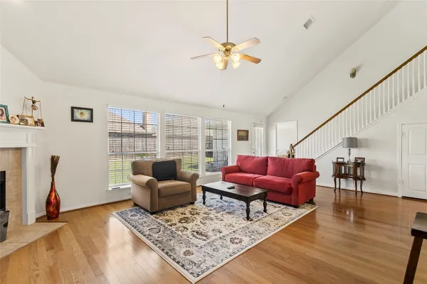 a living room with furniture and a wooden floor